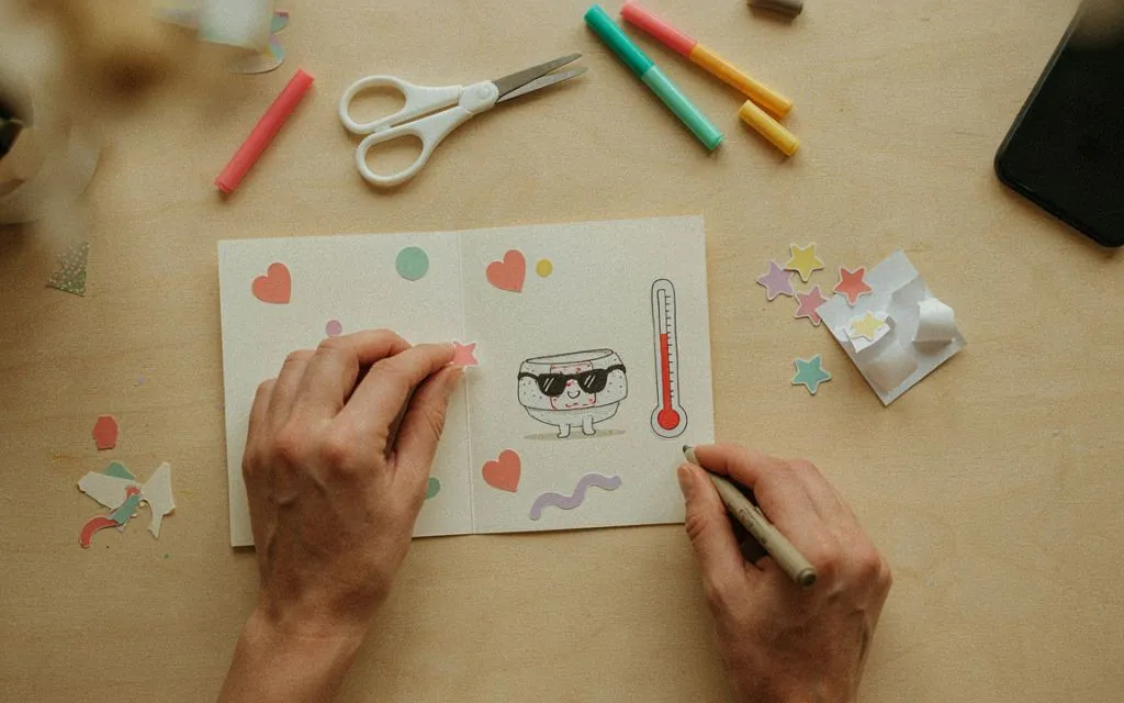 Handmade humorous get-well card with colorful craft supplies.