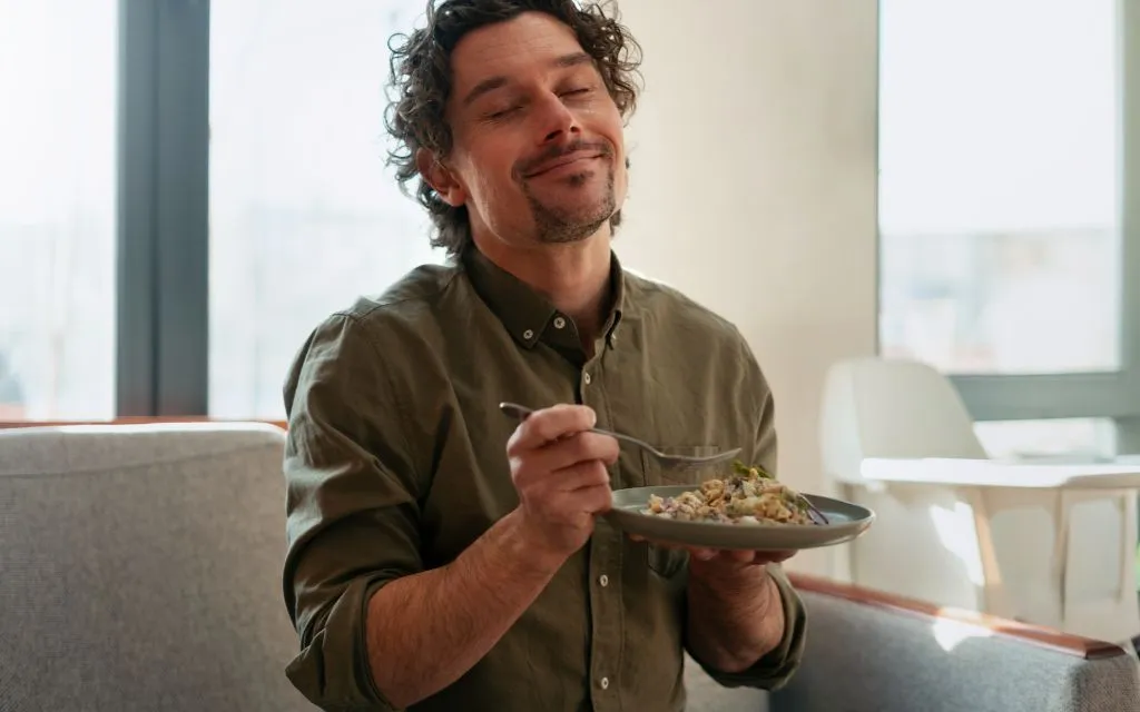 A man enjoying a mindful meal as part of a daily healthy eating routine.
